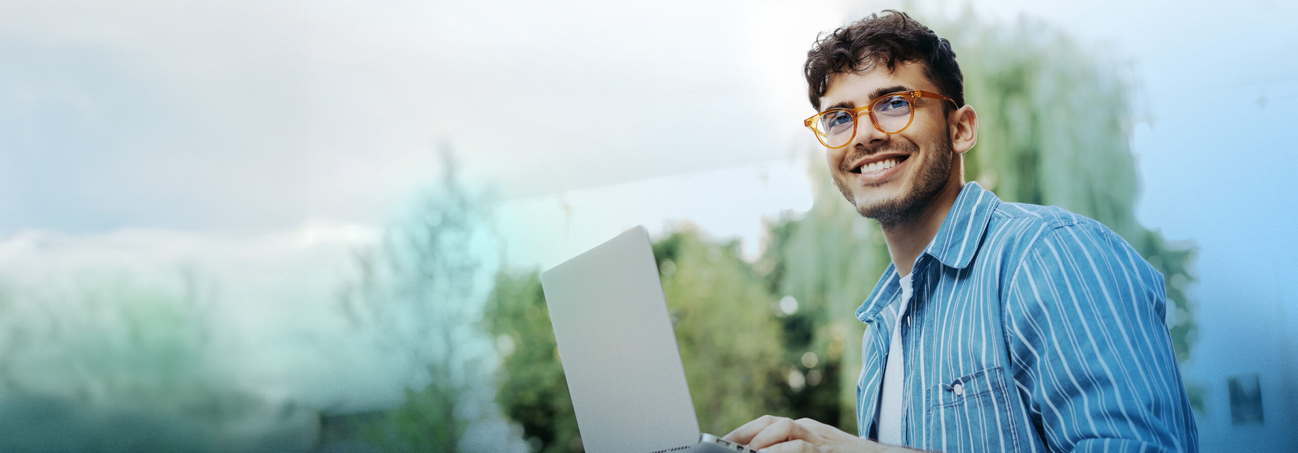 Portrait of handsome Indian copywriter using laptop computer, ty